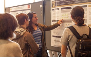 Student presenting a research poster.