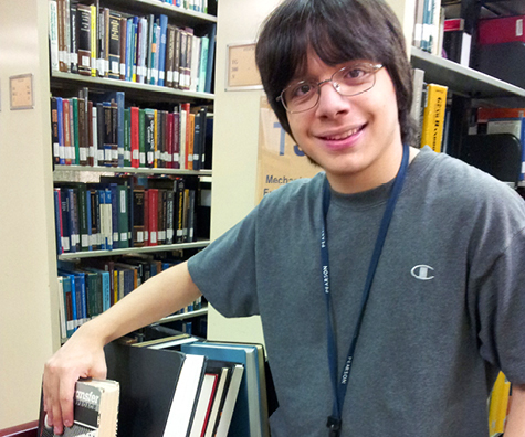 Photo of young adult working in library