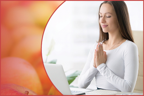 Woman practicing deep breathing exercises at her desk