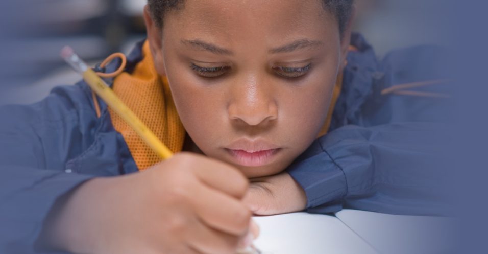 boy writing and take assessment