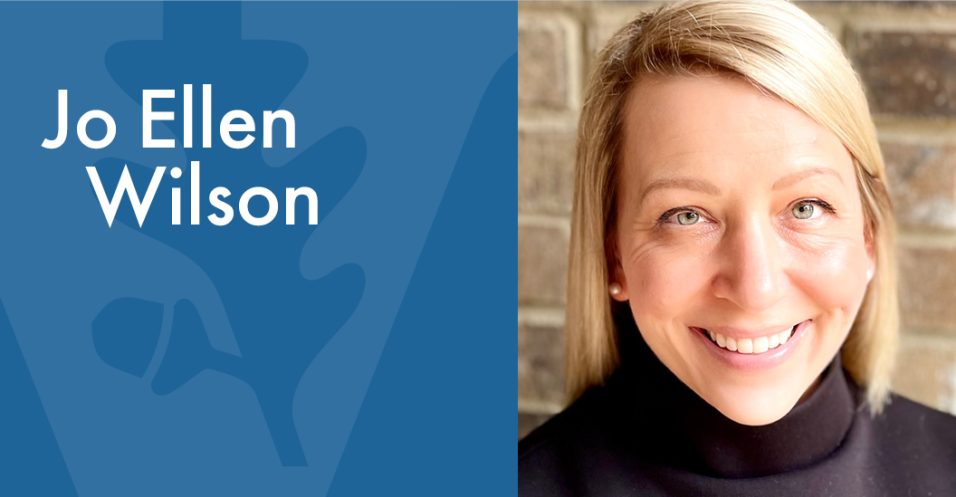 Graphic layout with a portrait photo on the right and a blue panel on the left displaying large white text that reads ‘Jo Ellen Wilson.’